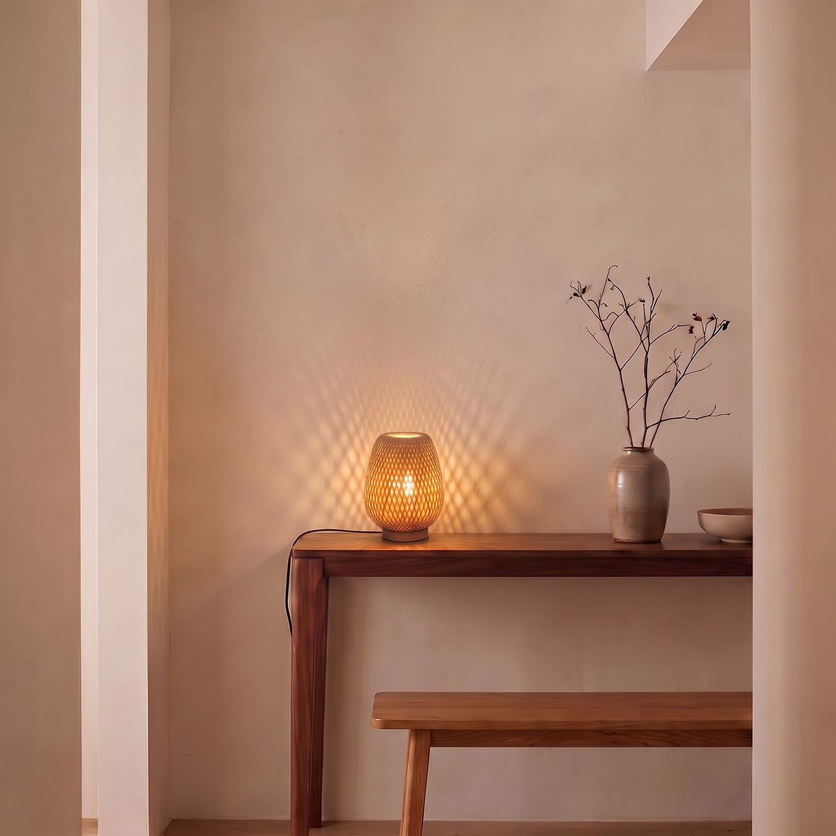 Bamboo lattice table lamp casting diamond shadows in an entry hall