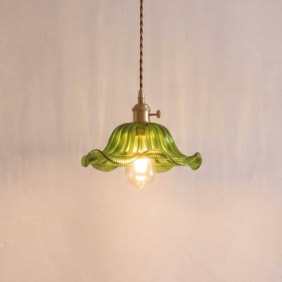 Green ruffled glass pendant with brass socket over a breakfast table