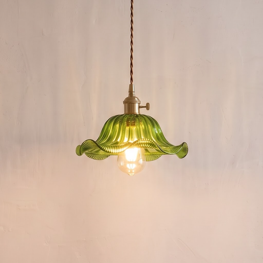 Green ruffled glass pendant with brass socket over a breakfast table
