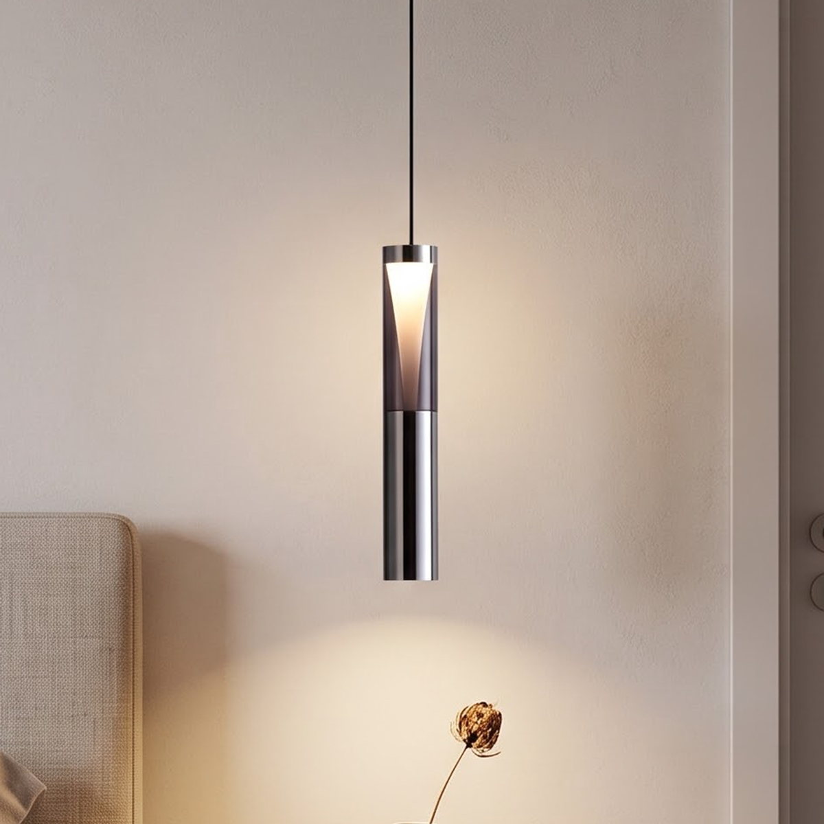 Slim smoked-grey cylinder pendant light glowing beside a Japandi bed