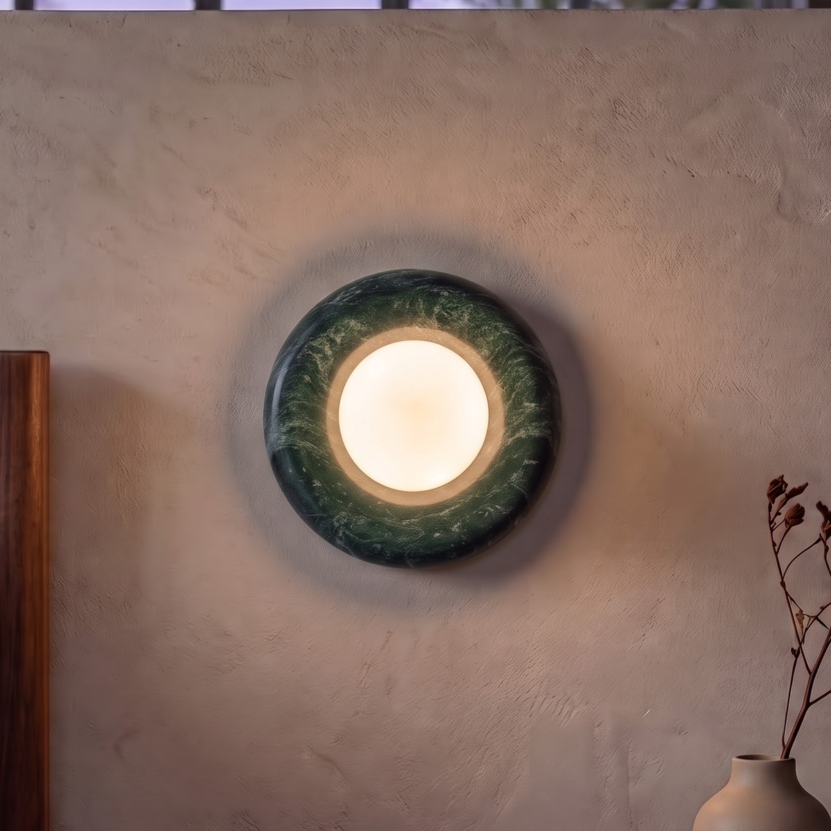 Forest green marble disc wall light above a dining room sideboard