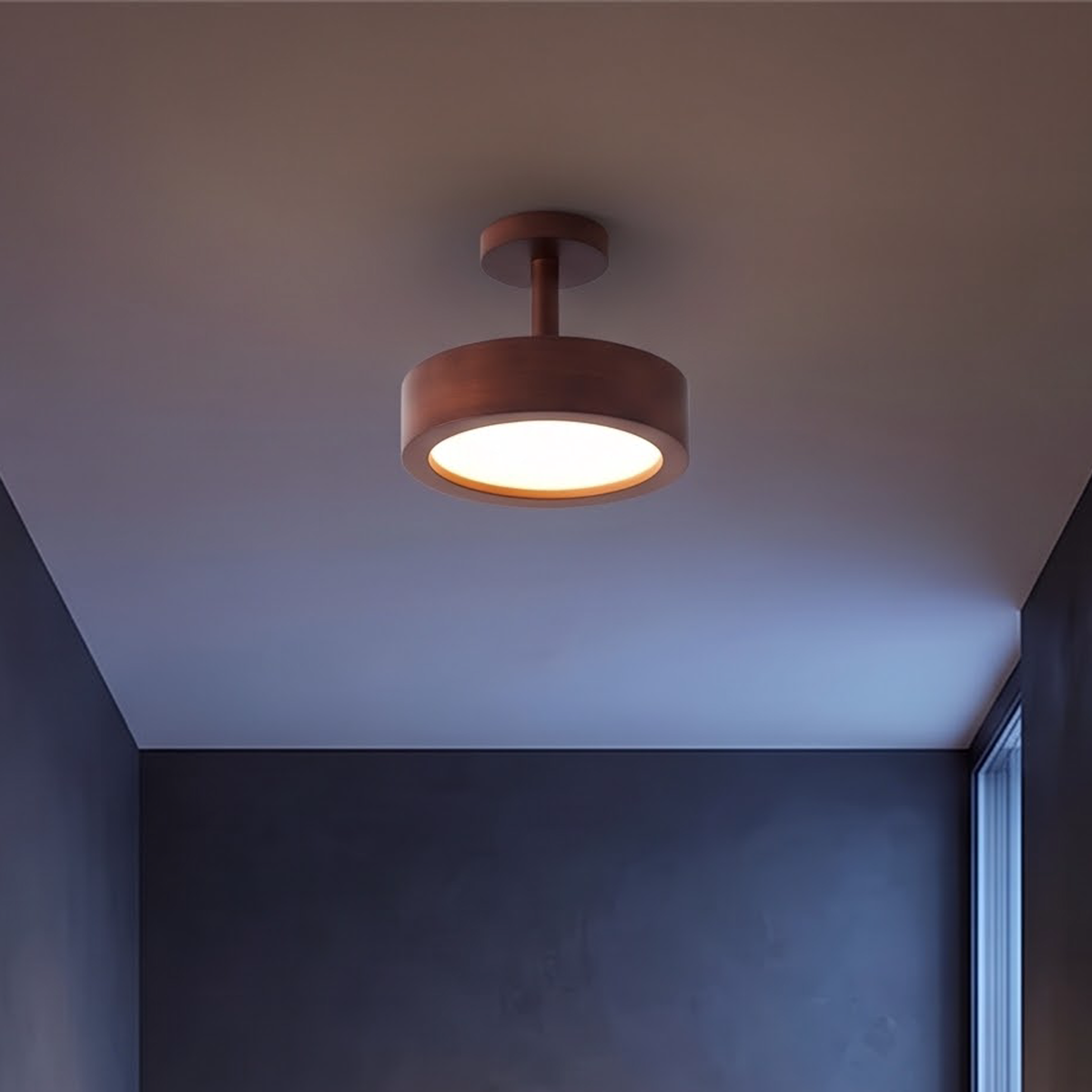 Walnut wood semi-flush ceiling light glowing above a front entry