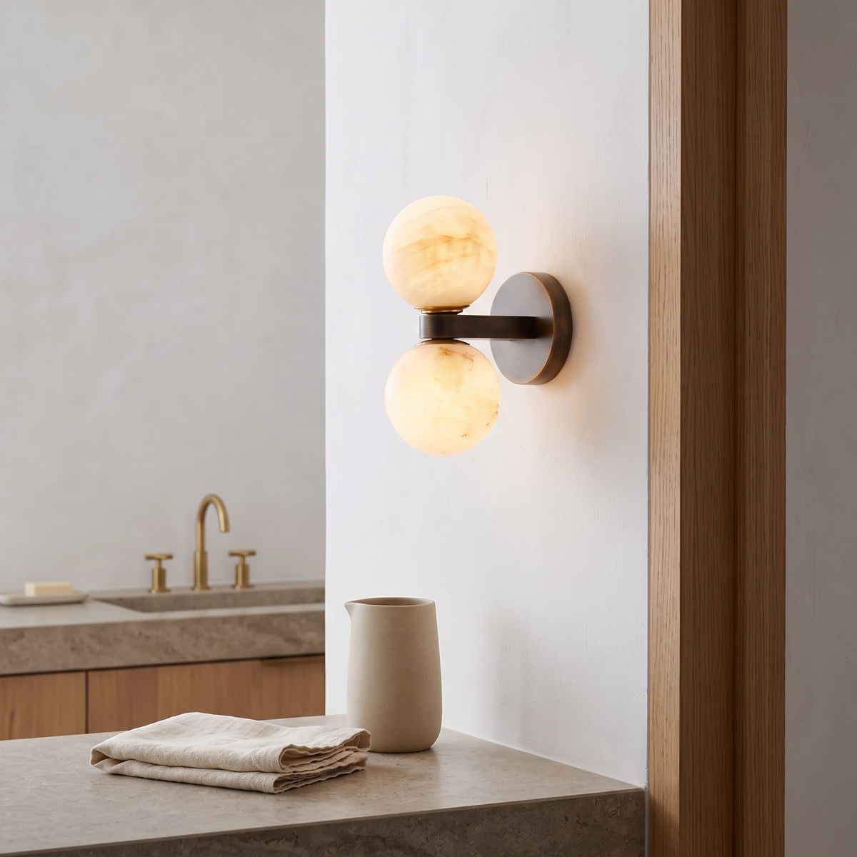 Double marble globe wall lamp in a microcement spa bathroom