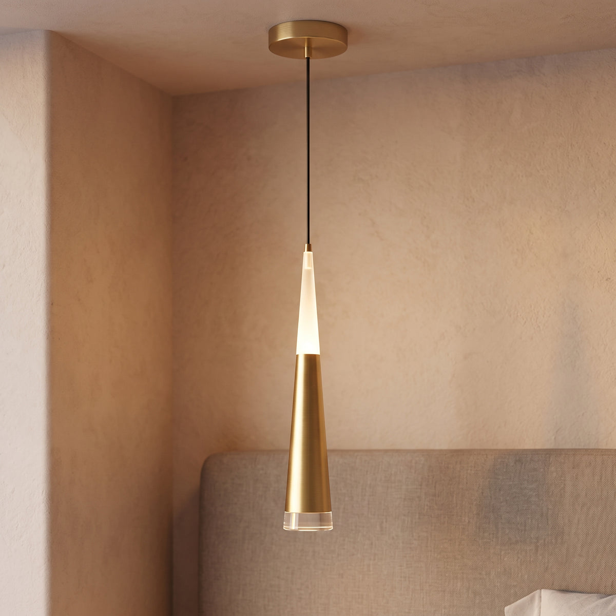Close detail of a gold cone mini pendant with acrylic tip glowing