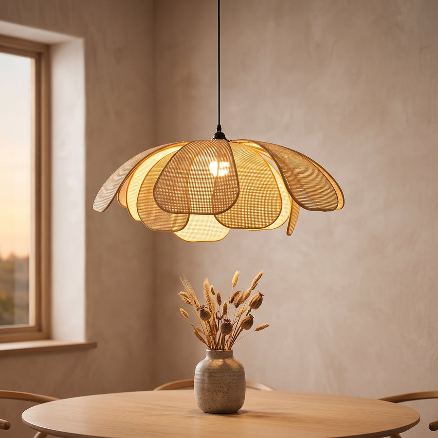 Rattan petal pendant light glowing over a round oak dining table