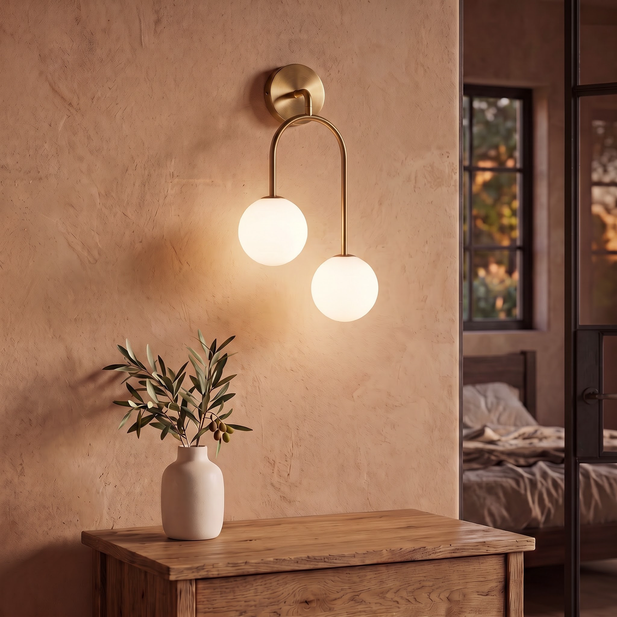 Brass U-arch wall sconce with two opal globes above an oak dresser