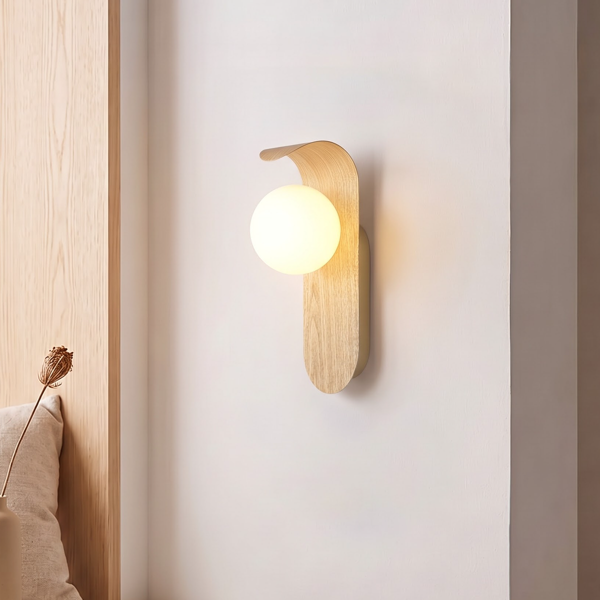 Pale wood-grain wall light with frosted globe beside a window seat