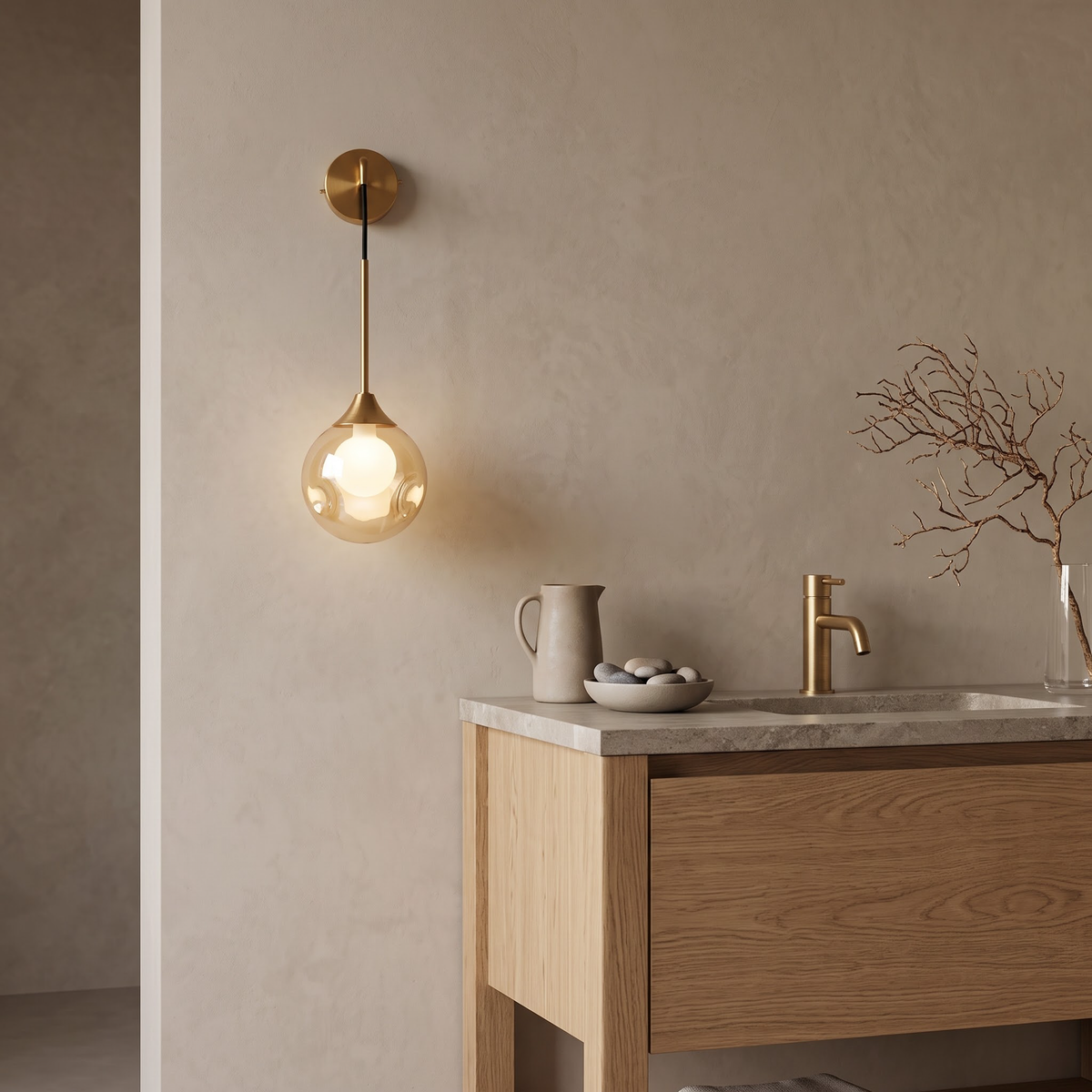 Amber glass globe wall sconce beside an oak bathroom vanity