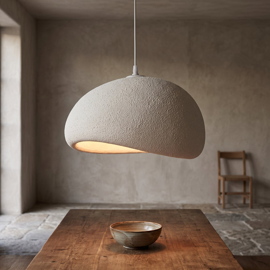 Pebble-shaped wabi-sabi pendant light over an oak dining table