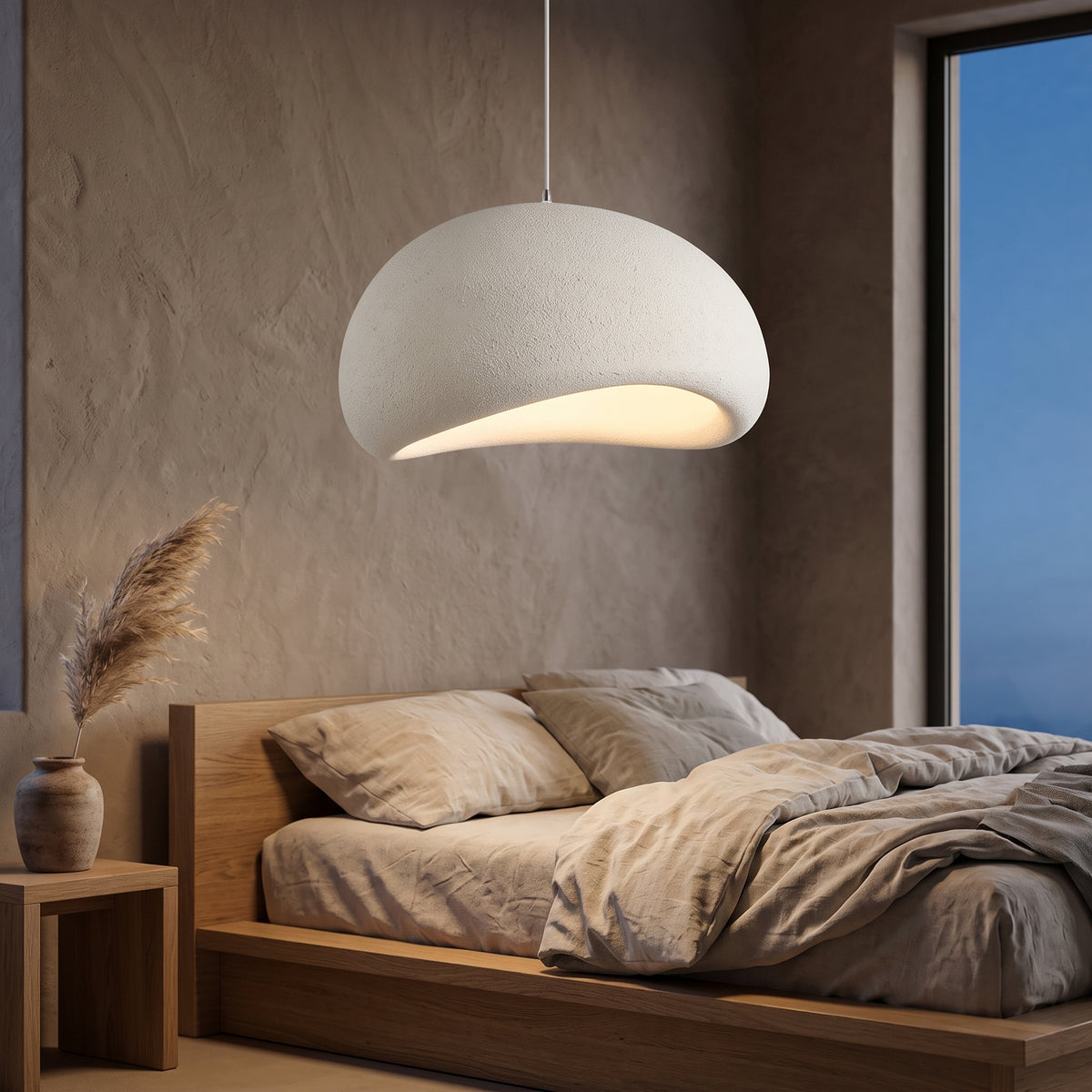 Wabi-sabi textured pendant lamp glowing in a plaster-walled bedroom