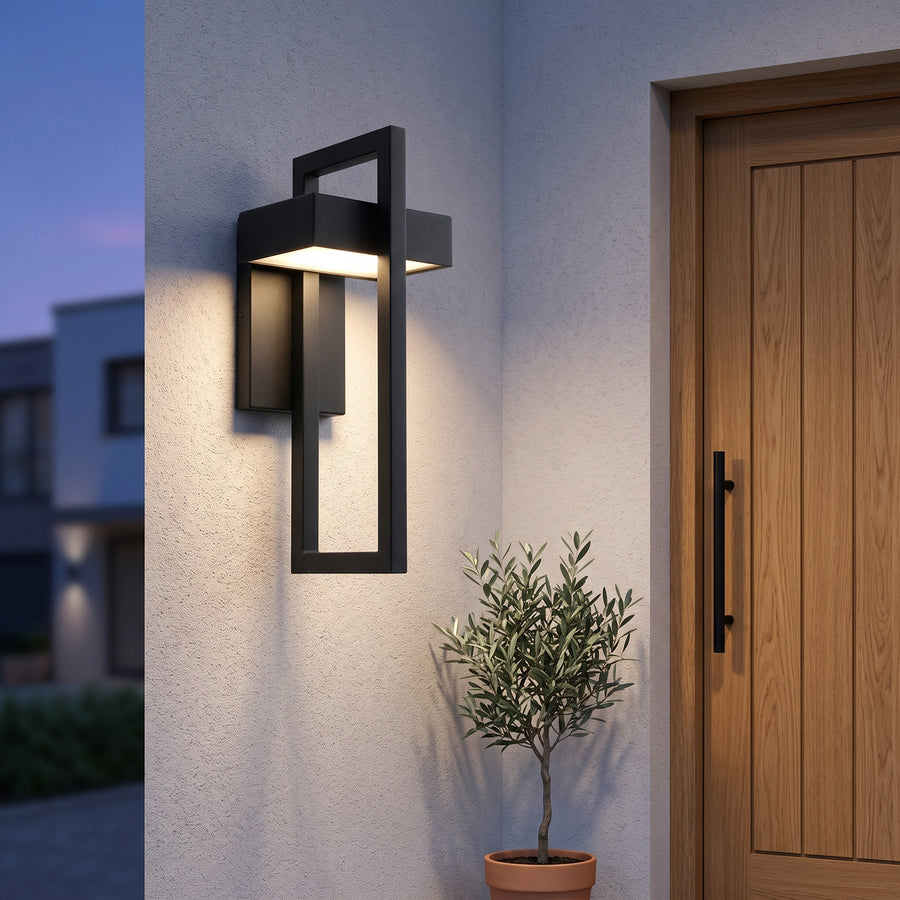 Black rectangular outdoor wall light beside a front door at dusk