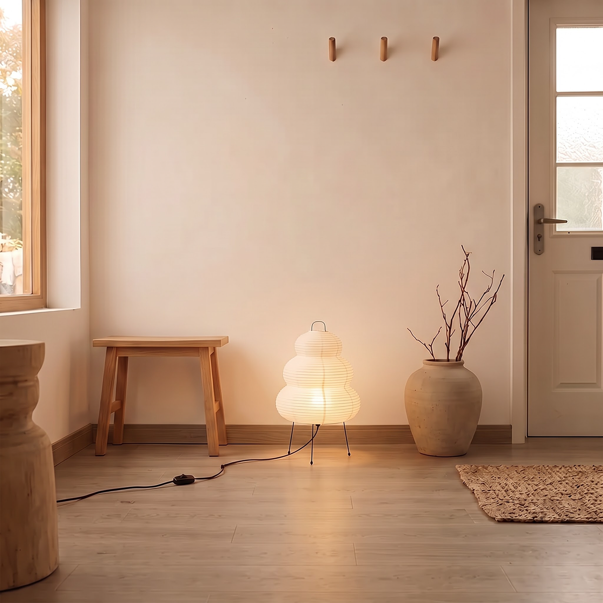 White three-tier paper lantern lamp beside an oak bench in a hallway