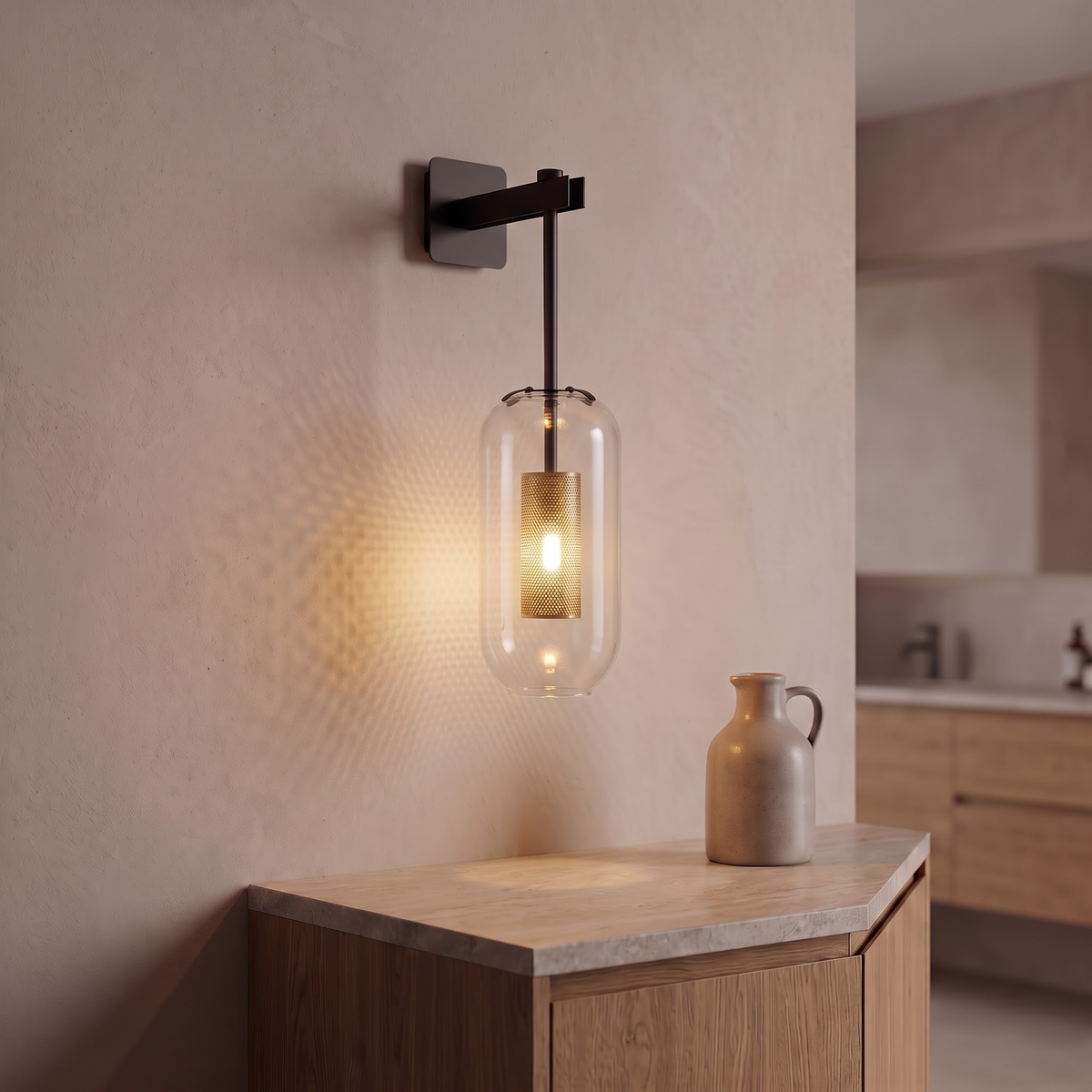 Black and clear glass capsule wall sconce beside a bathroom vanity