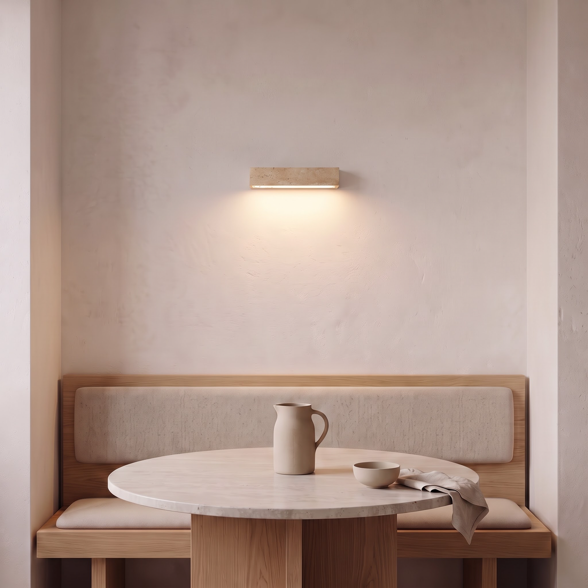 Single travertine bar wall light above an oak dining banquette