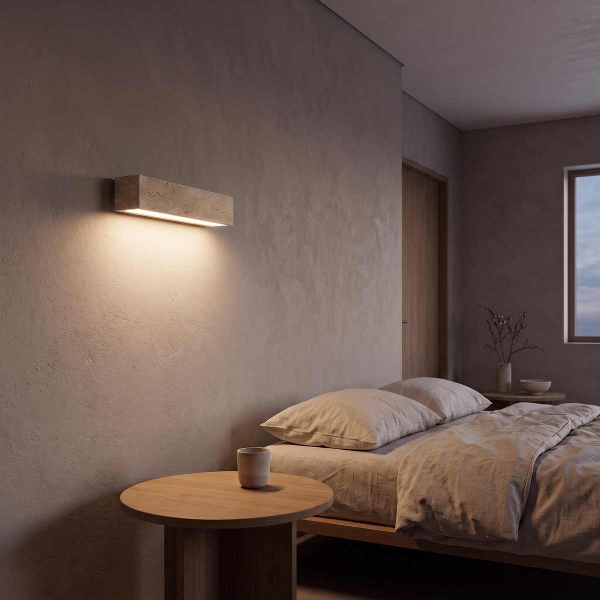 Travertine bar wall light beside a low bed in a wabi-sabi bedroom