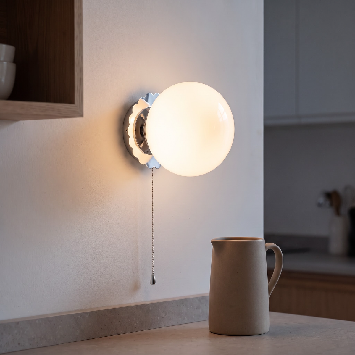 White glass globe wall light on a chrome plate in a kitchen nook