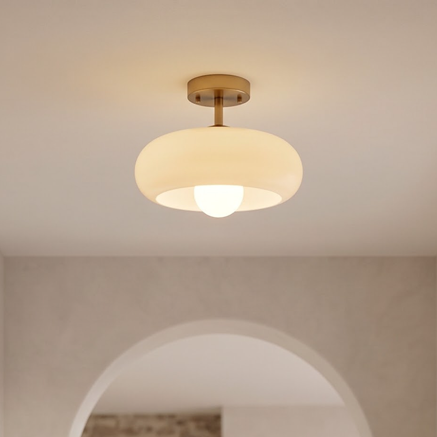 Cream glass semi-flush ceiling light glowing in an arched entry hall