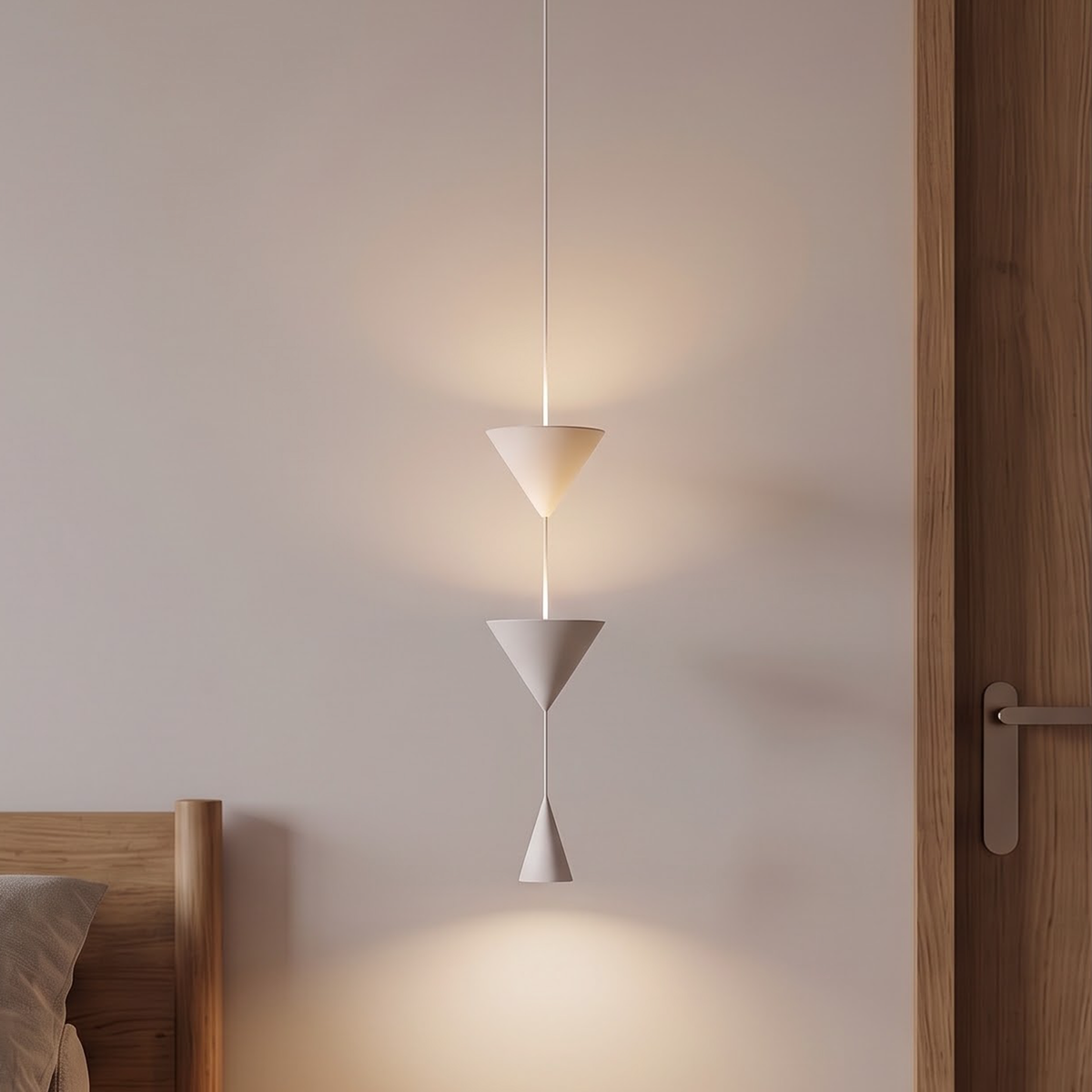 White triple cone pendant light hanging beside a bed at dusk