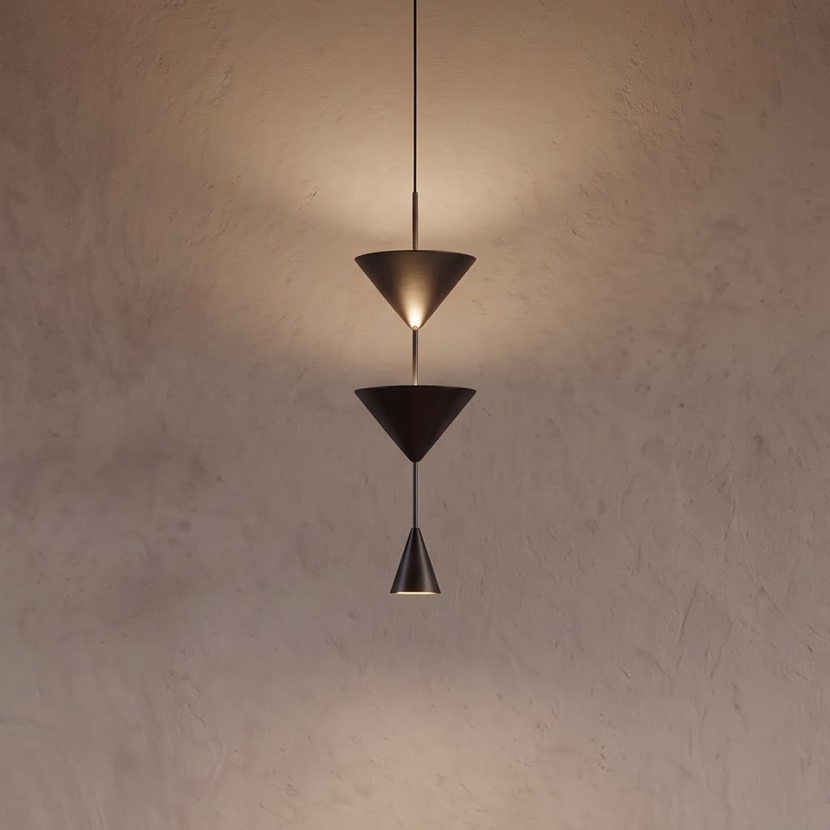 Black triple cone pendant light above a walnut side table