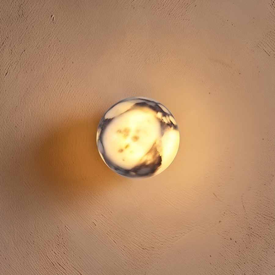Glowing veined marble ball wall light above an oak nightstand