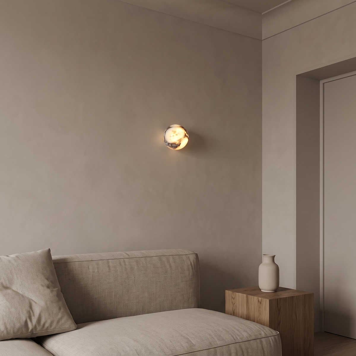 Veined marble sphere wall light above a linen sofa in the evening