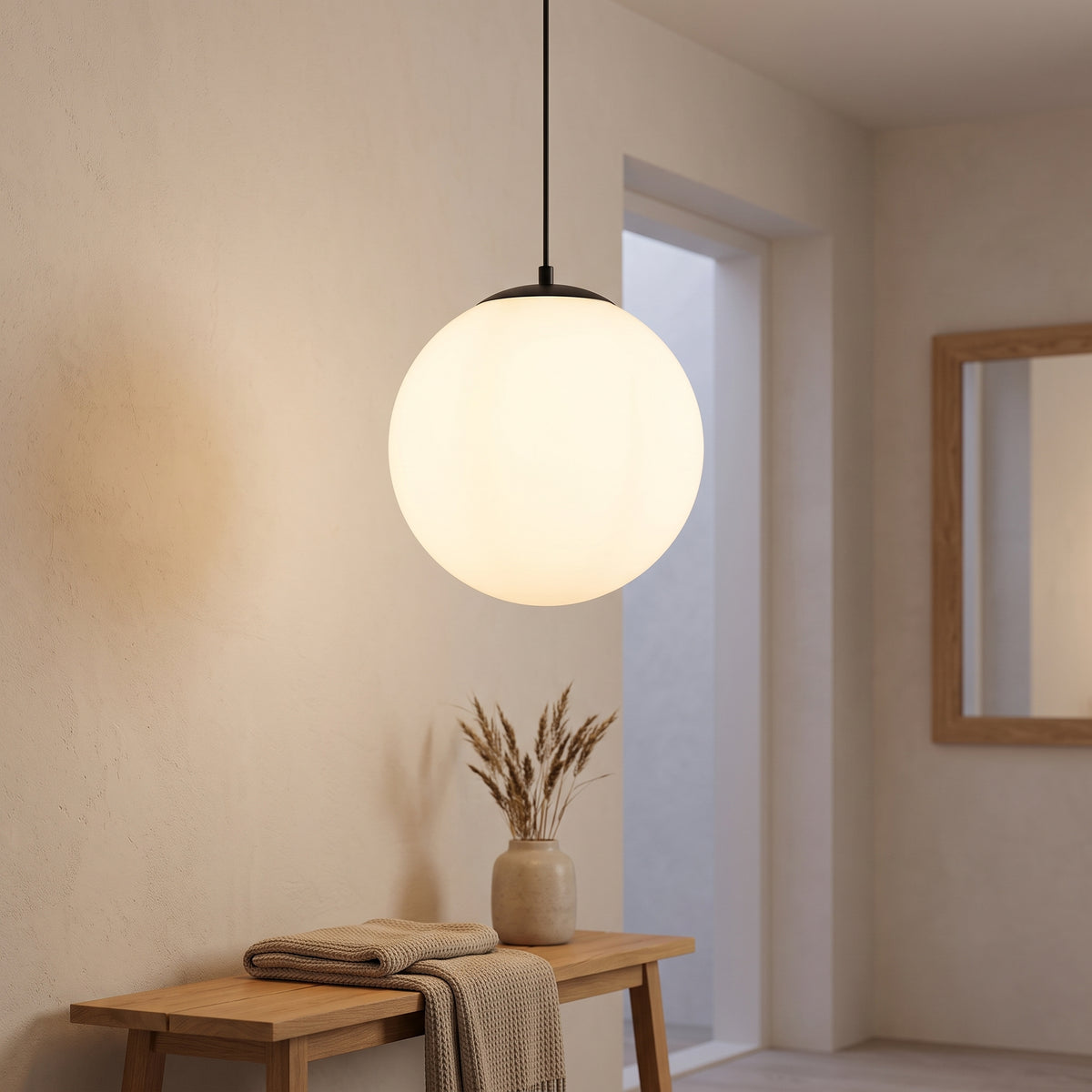 Opal globe pendant with black canopy lighting a Nordic entry hall