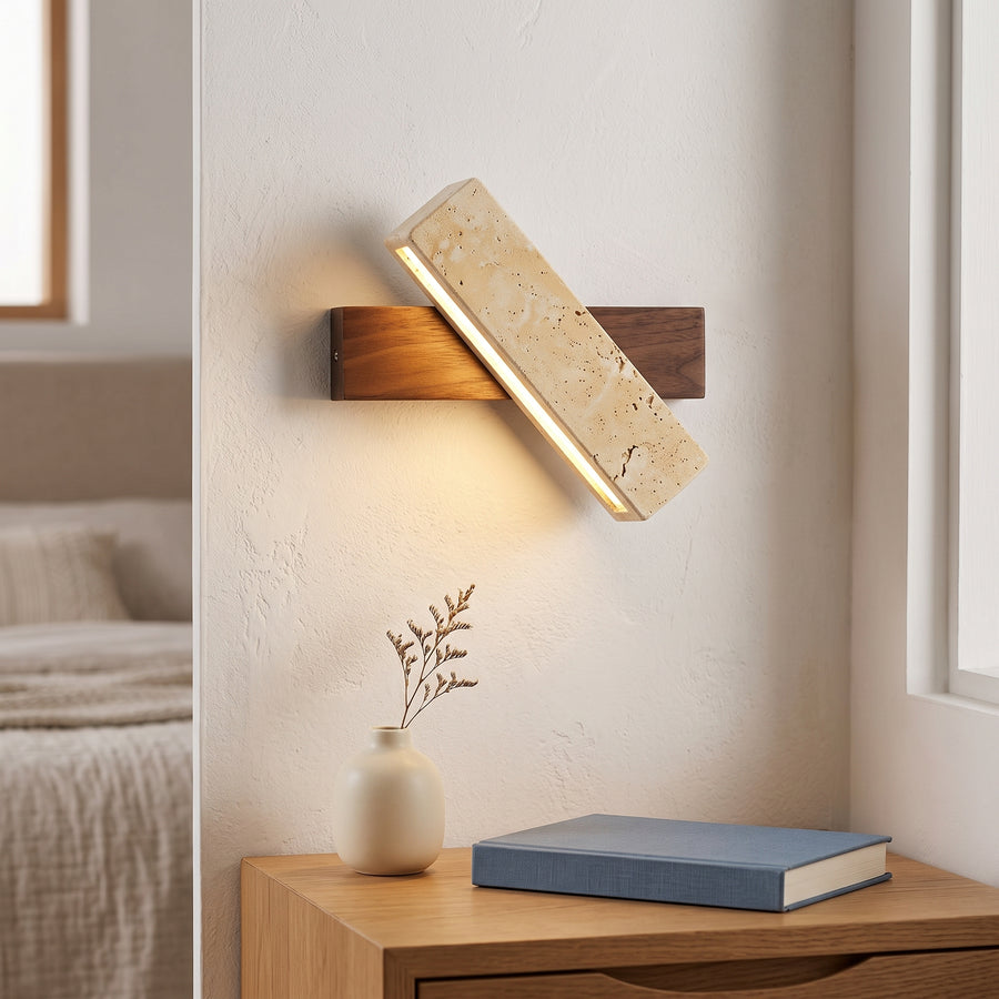 Travertine bar wall sconce on walnut base above an oak nightstand