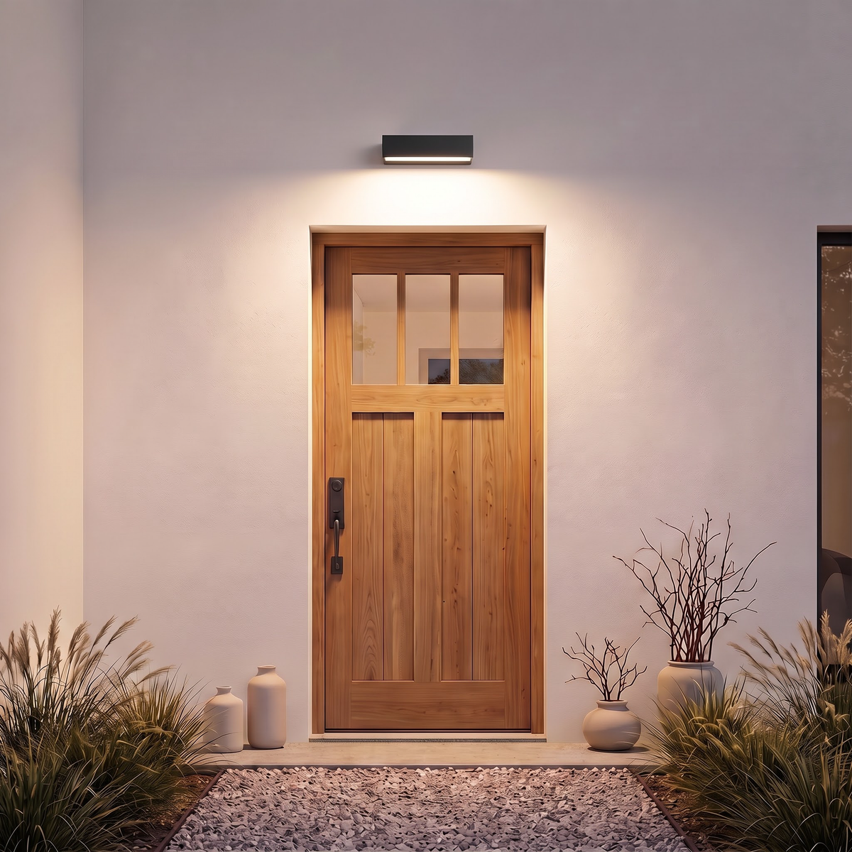 Black outdoor wall washer light above a plank oak front door