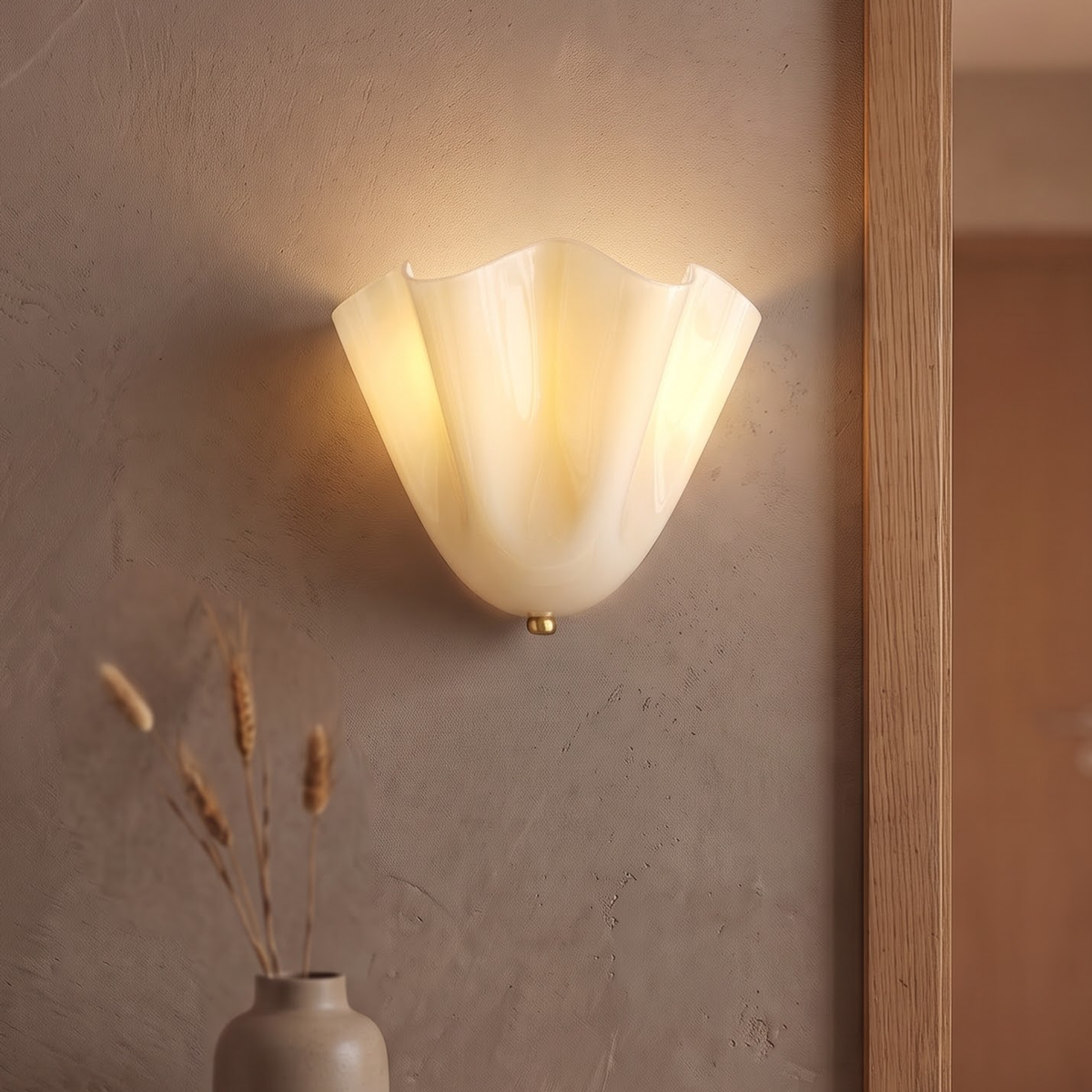 Cream rippled glass flower wall sconce glowing beside a doorway