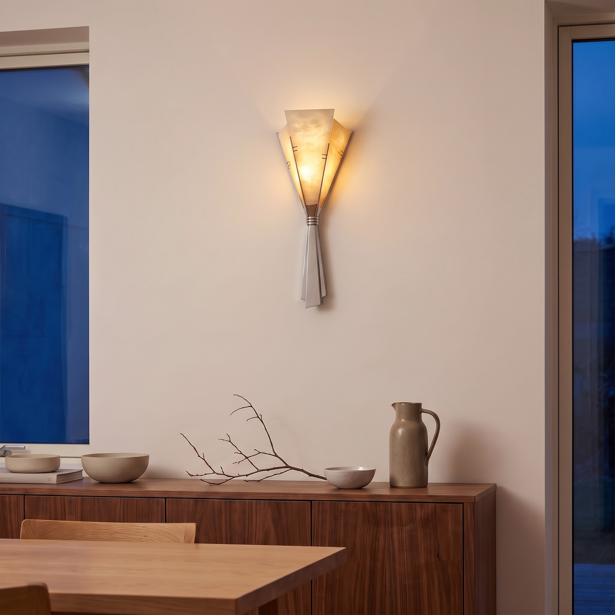 Stone fan wall sconce above a walnut sideboard in a dining room