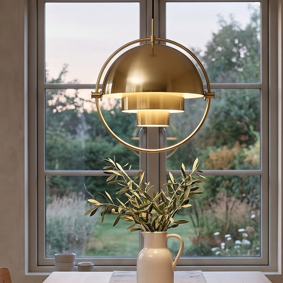 Gold ring pendant light with stepped dome shade over a dining table