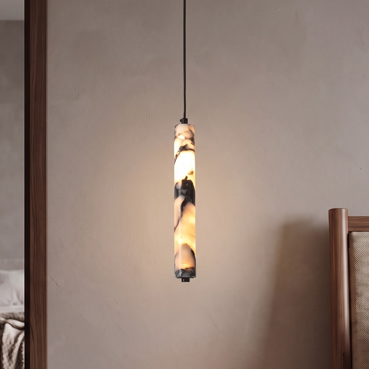 Slim veined stone cylinder pendant glowing beside a walnut nightstand