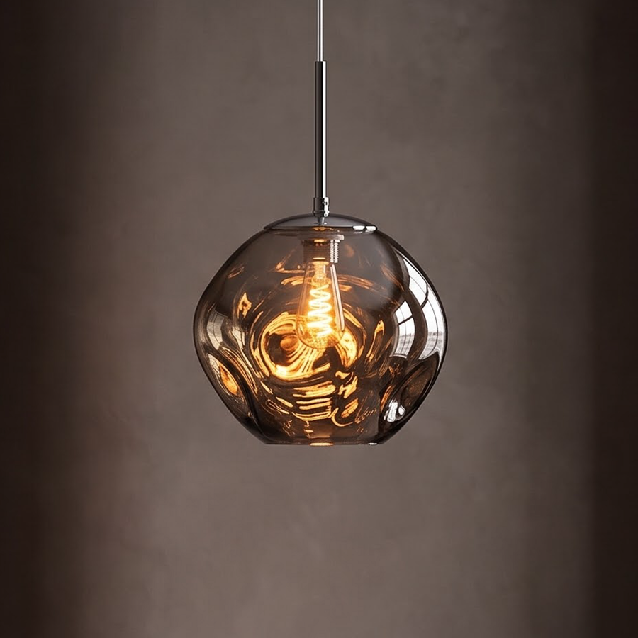 Smoke grey molten glass pendant light glowing over a dark oak table
