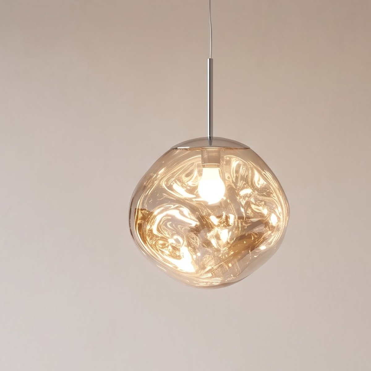 Silver molten glass pendant light hanging over a walnut nightstand