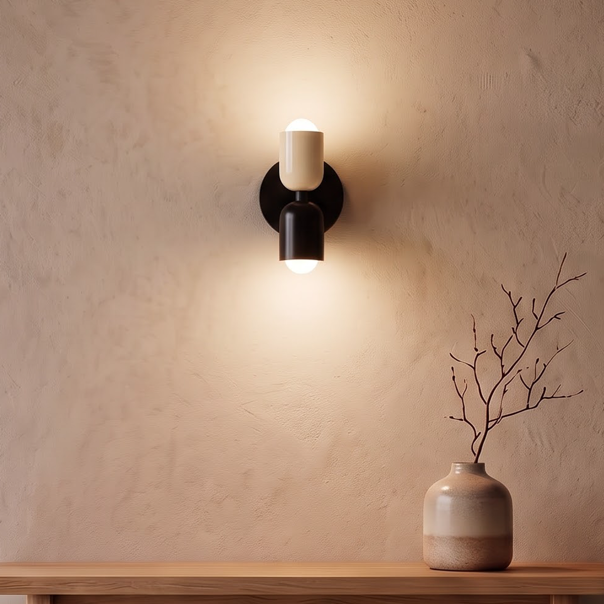 Cream and black up and down wall sconce above an oak console