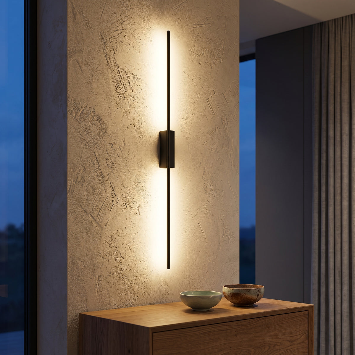 Black horizontal LED bar wall light above an oak sideboard