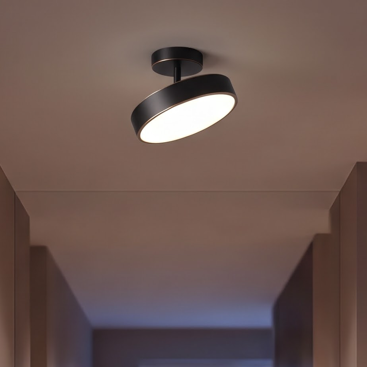 Black semi-flush ceiling light with brass rim on a stair landing