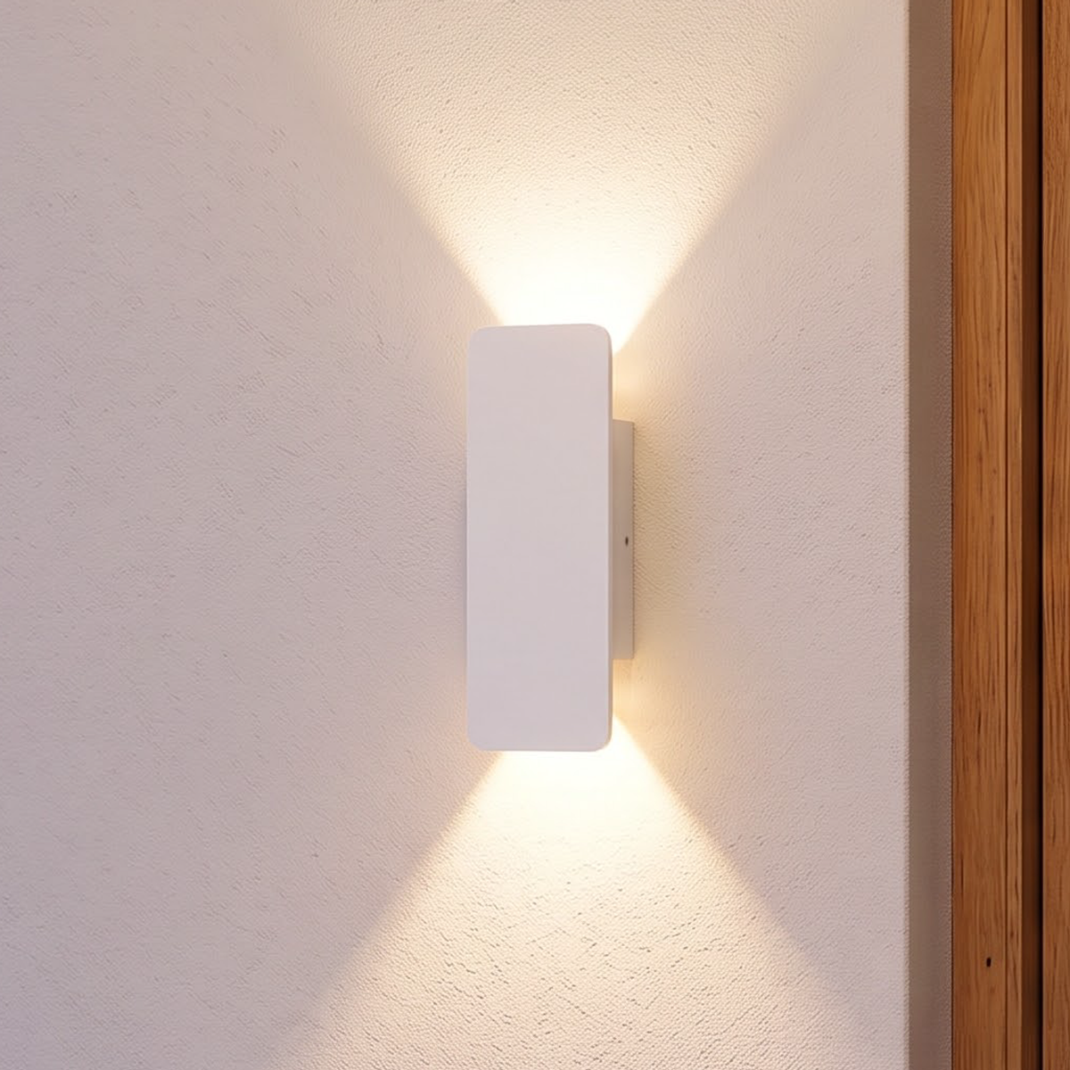 White slim up-down outdoor wall light beside an oak front door