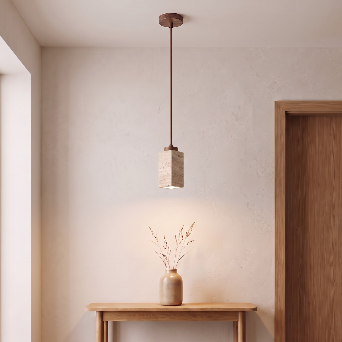 Square travertine stone pendant above an oak console in an entry