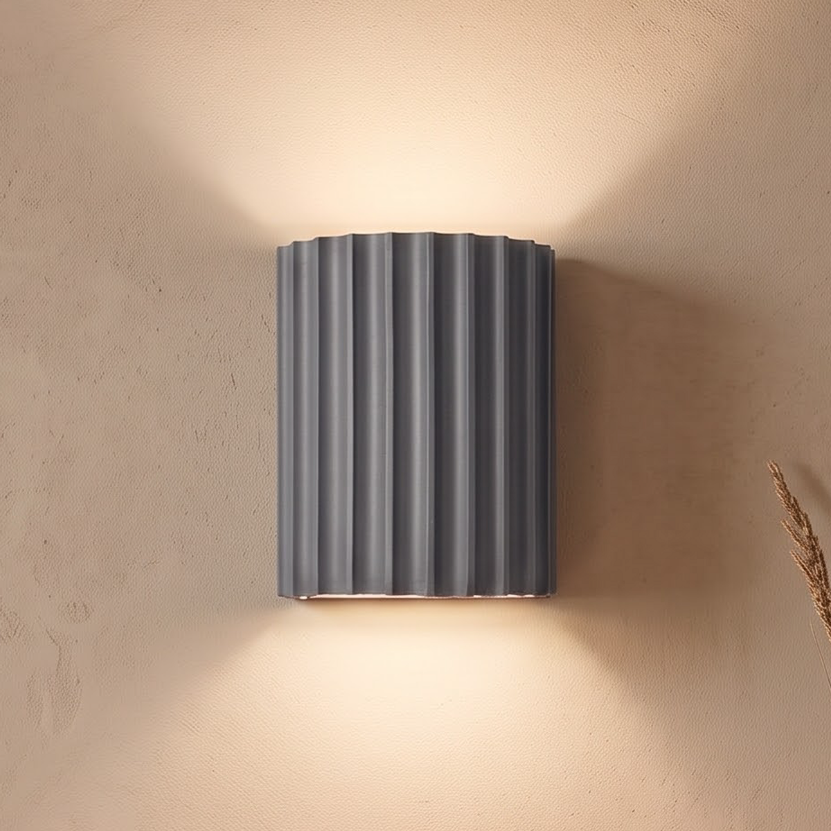 Slate grey fluted wall light above an oak sideboard in the evening