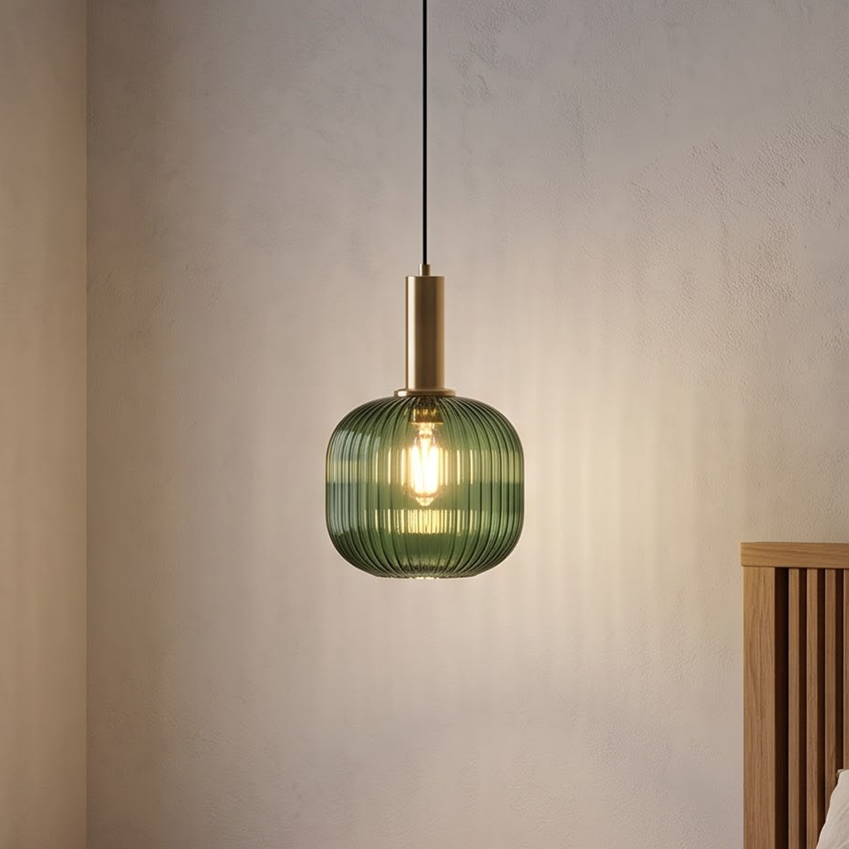 Green ribbed glass pendant light over a stone kitchen island