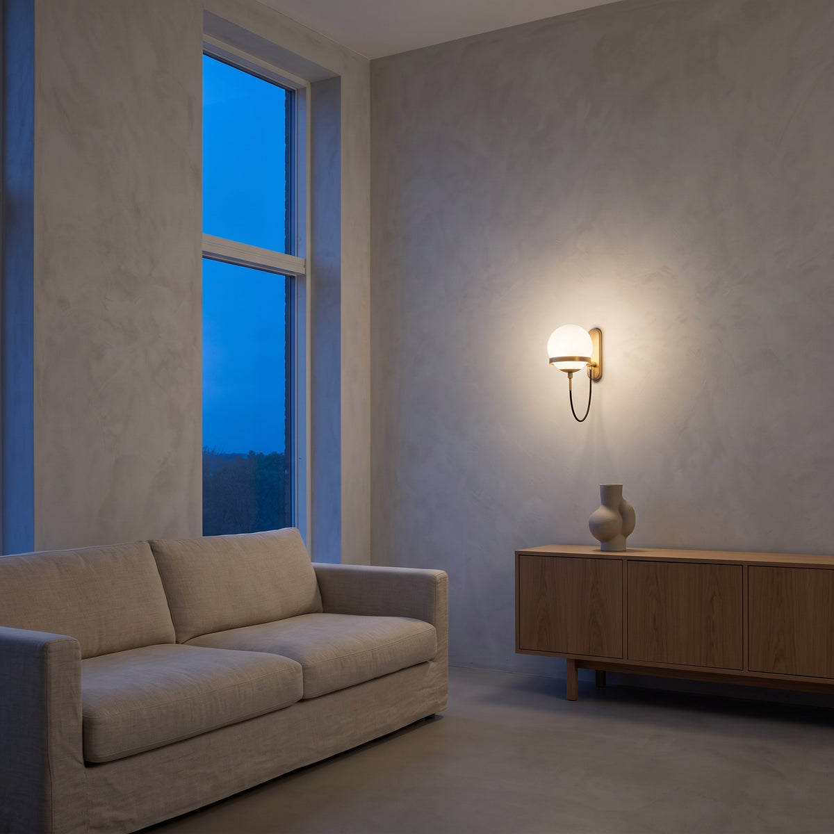Gold opal globe wall light glowing above an oak sideboard in a living room