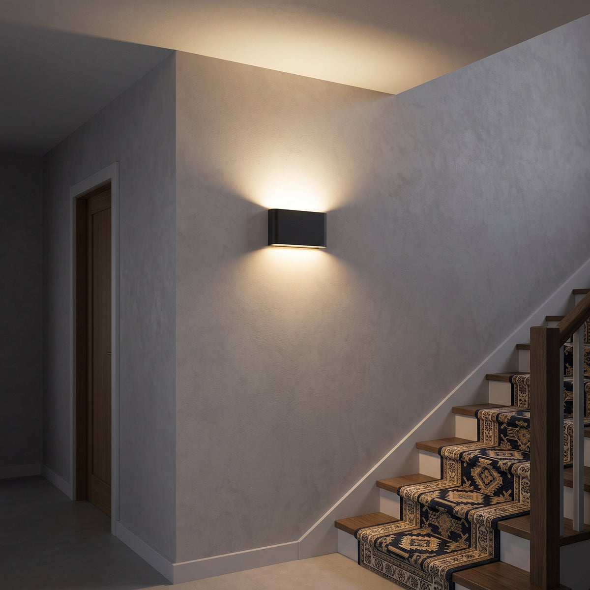 Black indoor/outdoor block wall light in a microcement hallway at night