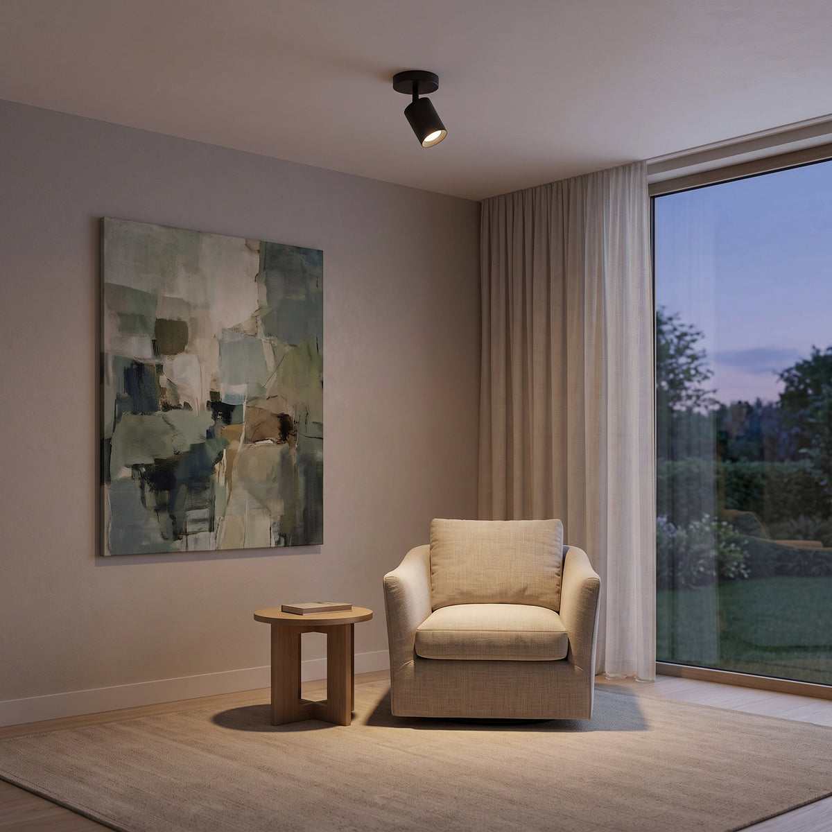 Small black Ten ceiling spotlight lighting an armchair in a calm living room