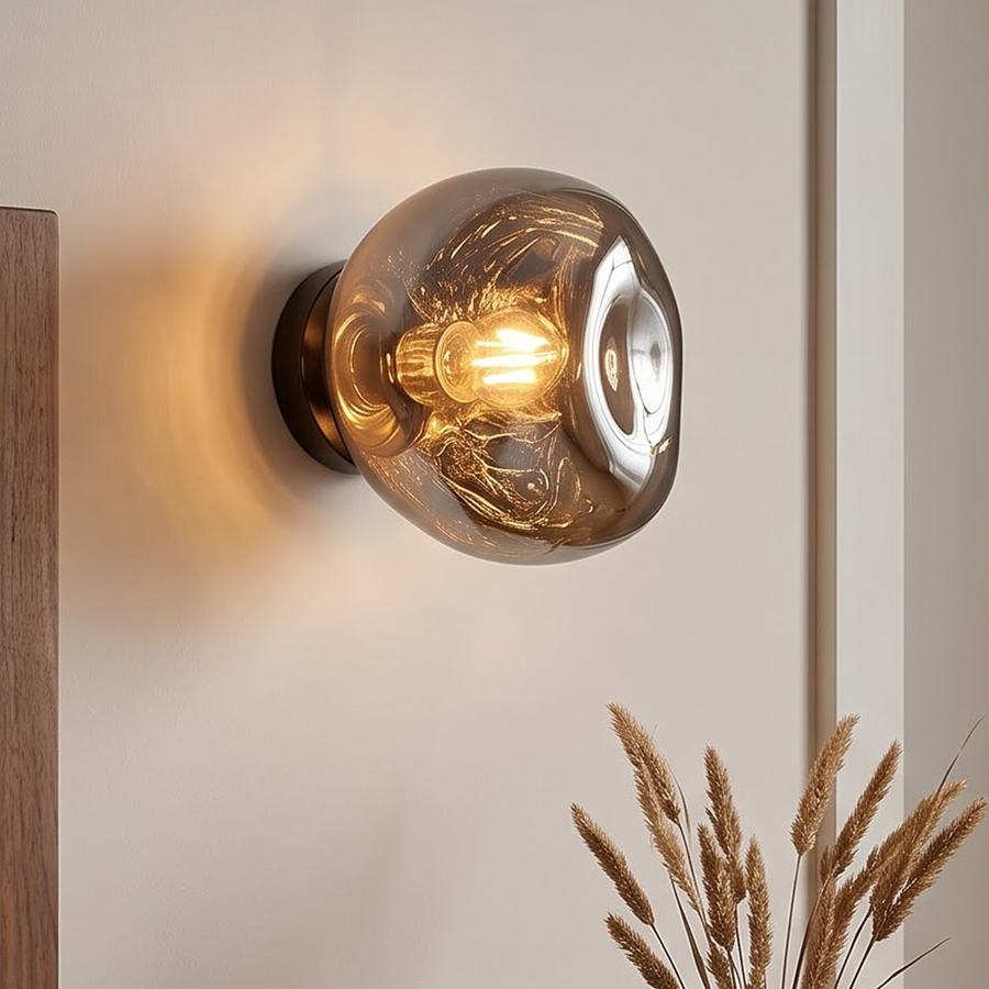 Smoke grey molten glass wall light glowing beside a doorway