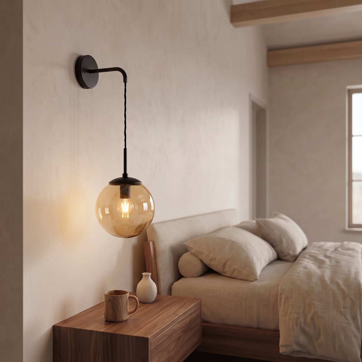 Tomo Glass Globe Wall Sconce in Black, Amber, switched on, close view
