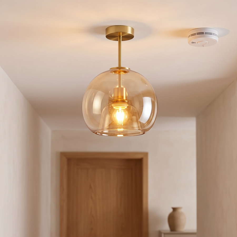 Cognac glass dome ceiling light glowing in a limewashed hallway
