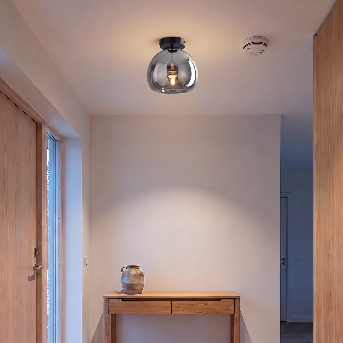 Smoke grey glass flush ceiling light in a Japandi entry hall