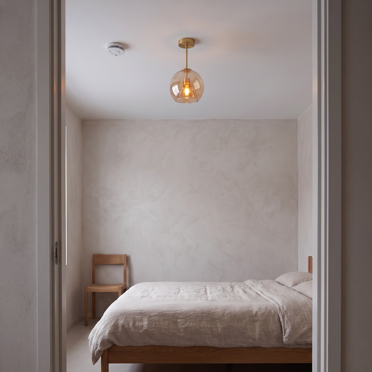 Cognac glass semi-flush ceiling light above a low oak bed