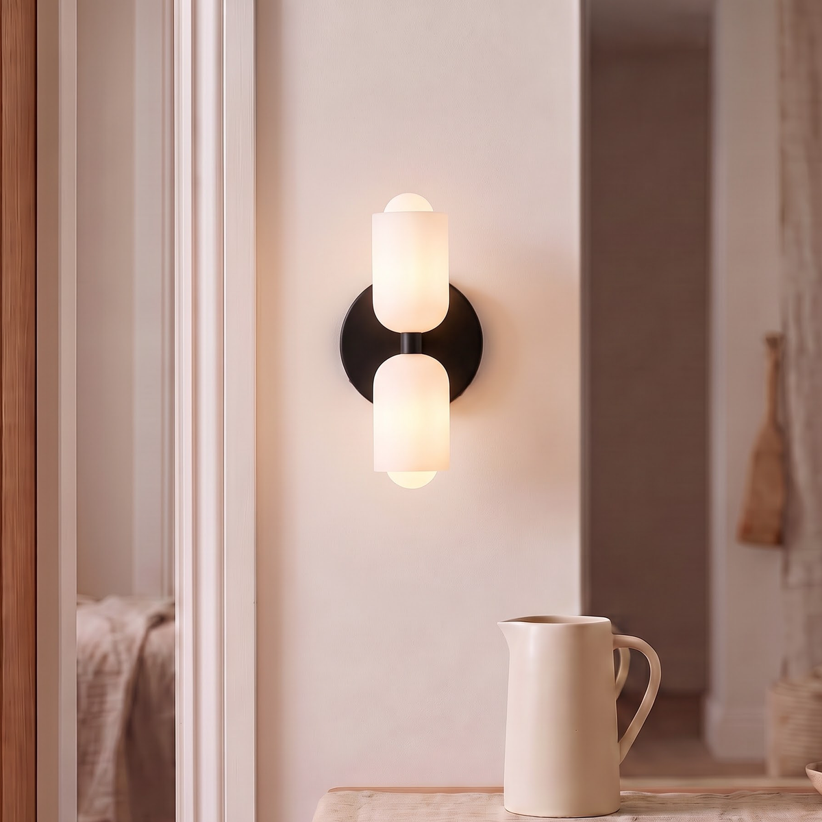 Black double wall sconce with two opal shades above a reading table